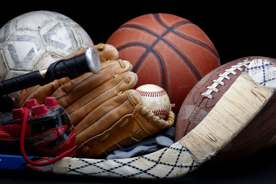 assorted sports equipment on a black background